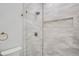 Clean bathroom with a walk-in shower, and marble-look tile at 325 33Rd N Ave, St Petersburg, FL 33704