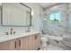 Bathroom with a shower/tub combo, double vanity, and marble tile at 325 33Rd N Ave, St Petersburg, FL 33704