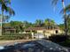 Community pool area with gate entry, cabana, and lush landscaping at 2620 Locksley St # 261, Sun City Center, FL 33573