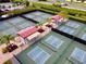 Aerial view of community pickleball courts with covered seating areas at 2620 Locksley St # 261, Sun City Center, FL 33573
