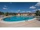 Large community pool with people enjoying a sunny day at 2620 Locksley St # 261, Sun City Center, FL 33573