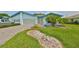 Light blue home exterior with double garage and landscaping at 2620 Locksley St # 261, Sun City Center, FL 33573
