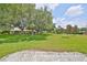 Spacious front yard with mature trees and landscaping at 2620 Locksley St # 261, Sun City Center, FL 33573