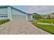 Light blue house with a paved driveway and manicured lawn at 2620 Locksley St # 261, Sun City Center, FL 33573