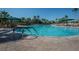 Large resort-style pool with plenty of lounge chairs and umbrellas at 2620 Locksley St # 261, Sun City Center, FL 33573