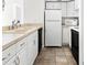 Kitchen with white cabinets, tile floor and appliances at 776 100Th N Ave # 104, St Petersburg, FL 33702