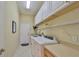 Laundry room with washer, dryer, and ample shelving at 804 Regal Manor Way, Sun City Center, FL 33573