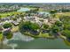 Aerial view of community with homes, golf course, and lakes at 804 Regal Manor Way, Sun City Center, FL 33573