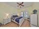 Bright bedroom with a comfortable queen-size bed and wood flooring at 804 Regal Manor Way, Sun City Center, FL 33573