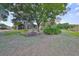 Spacious backyard with lush landscaping, screened patio, and pond view at 804 Regal Manor Way, Sun City Center, FL 33573