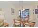 Casual dining area with glass table and wicker chairs, overlooking patio at 804 Regal Manor Way, Sun City Center, FL 33573