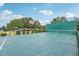 Community outdoor basketball court with backboard and wall at 804 Regal Manor Way, Sun City Center, FL 33573