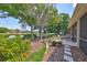 Landscaped backyard with pond view and patio furniture at 804 Regal Manor Way, Sun City Center, FL 33573