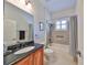 Clean bathroom with a shower/tub combo and dark vanity at 804 Regal Manor Way, Sun City Center, FL 33573