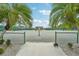 Community tennis court with palm trees and fencing at 804 Regal Manor Way, Sun City Center, FL 33573