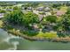 Aerial view showcasing home's waterfront lot and lush surroundings at 804 Regal Manor Way, Sun City Center, FL 33573