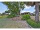Spacious backyard with lush landscaping and a view of the lake at 804 Regal Manor Way, Sun City Center, FL 33573
