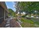 Private backyard oasis with a tranquil lake view and lush landscaping at 804 Regal Manor Way, Sun City Center, FL 33573