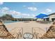 Lounge chairs and tables surround the refreshing community pool at 804 Regal Manor Way, Sun City Center, FL 33573