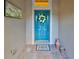 Inviting entryway with teal door, welcome mat, and decorative wreath at 804 Regal Manor Way, Sun City Center, FL 33573