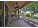 Spacious screened-in porch overlooking a lake, furnished for relaxation at 804 Regal Manor Way, Sun City Center, FL 33573