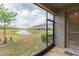 Peaceful screened patio overlooking a pond and community at 8065 Rolling Shell Trl, Wesley Chapel, FL 33545