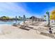 Relaxing pool deck with numerous lounge chairs and umbrellas at 8065 Rolling Shell Trl, Wesley Chapel, FL 33545