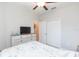 Bright bedroom with double doors and TV at 8065 Rolling Shell Trl, Wesley Chapel, FL 33545