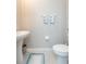 Simple half bathroom with pedestal sink and updated fixtures at 8065 Rolling Shell Trl, Wesley Chapel, FL 33545