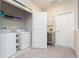 Laundry room with washer, dryer, and shelving at 8065 Rolling Shell Trl, Wesley Chapel, FL 33545