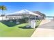 Covered outdoor seating area with tables and chairs at 8065 Rolling Shell Trl, Wesley Chapel, FL 33545