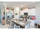 Spacious kitchen with white cabinets, granite island, and stainless steel appliances at 8065 Rolling Shell Trl, Wesley Chapel, FL 33545