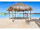 Relaxing beach cabana offering shade and waterfront views at 8065 Rolling Shell Trl, Wesley Chapel, FL 33545