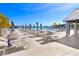 Spacious pool deck with lounge chairs and umbrellas at 8065 Rolling Shell Trl, Wesley Chapel, FL 33545
