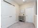 Hallway with linen closet and storage cabinet at 8065 Rolling Shell Trl, Wesley Chapel, FL 33545