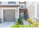 Townhome with a two-car garage and a private walkway entrance at 8065 Rolling Shell Trl, Wesley Chapel, FL 33545