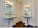 Elegant bathroom with and pedestal sinks, and dark tile flooring at 7510 N Mobley Rd, Odessa, FL 33556