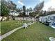 Spacious backyard with a paved pathway and lush green grass at 6902 Rhode Island Dr, Tampa, FL 33619