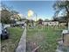 Overgrown vacant lot with distant homes and vehicles at 6902 Rhode Island Dr, Tampa, FL 33619