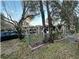 House exterior with mature trees and landscaping at 6902 Rhode Island Dr, Tampa, FL 33619