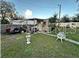 Small backyard with a car parked and a small sitting area at 6902 Rhode Island Dr, Tampa, FL 33619
