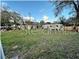 Empty lot with sparse grass and surrounding trees at 6902 Rhode Island Dr, Tampa, FL 33619