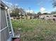 Vacant lot with sparse vegetation and distant buildings at 6902 Rhode Island Dr, Tampa, FL 33619