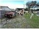Backyard with a damaged car and some debris at 6902 Rhode Island Dr, Tampa, FL 33619