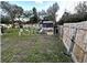 Small backyard with partial fence and grass at 6902 Rhode Island Dr, Tampa, FL 33619