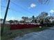 Lot with red fence and partial view of house at 6902 Rhode Island Dr, Tampa, FL 33619