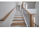 Elegant staircase with light wood steps and dark metal railing at 2345 Bahia Vista St, Sarasota, FL 34239