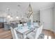 Modern dining room with white chairs and a gray table, open to kitchen at 2345 Bahia Vista St, Sarasota, FL 34239