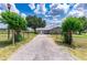 Gravel driveway leading to a stone ranch home at 31226 Saint Joe Rd, Dade City, FL 33525