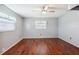 Hardwood floors and ceiling fan in this bright bedroom at 31226 Saint Joe Rd, Dade City, FL 33525